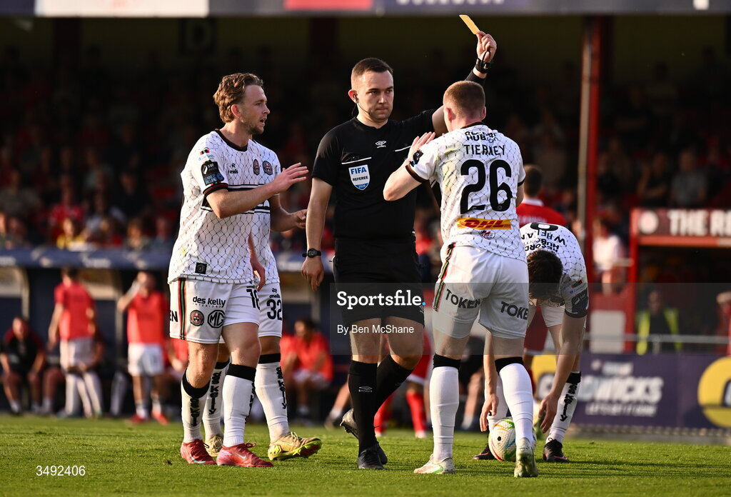 22 June 2026; Referee Kevin O'Sullivan issues a yellow card to Ross Tierney of Bohemians for simulation during the SSE Airtricity Men’s Premier Division match between Shelbourne and Bohemians at Tolka Park in Dublin. Photo by Ben McShane/Sportsfile