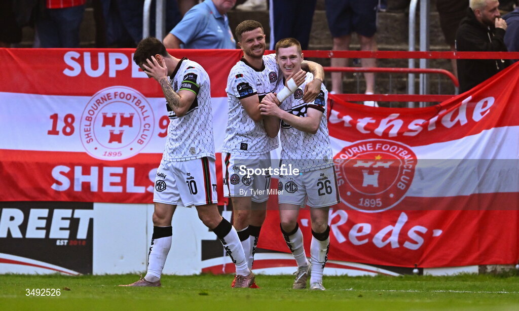 22 June 2026; Ross Tierney of Bohemians, right, celebrates with team-mates Dawson Devoy, left, and Adam McDonnell after scoring their side's third goal during the SSE Airtricity Men’s Premier Division match between Shelbourne and Bohemians at Tolka Park in Dublin. Photo by Tyler Miller/Sportsfile