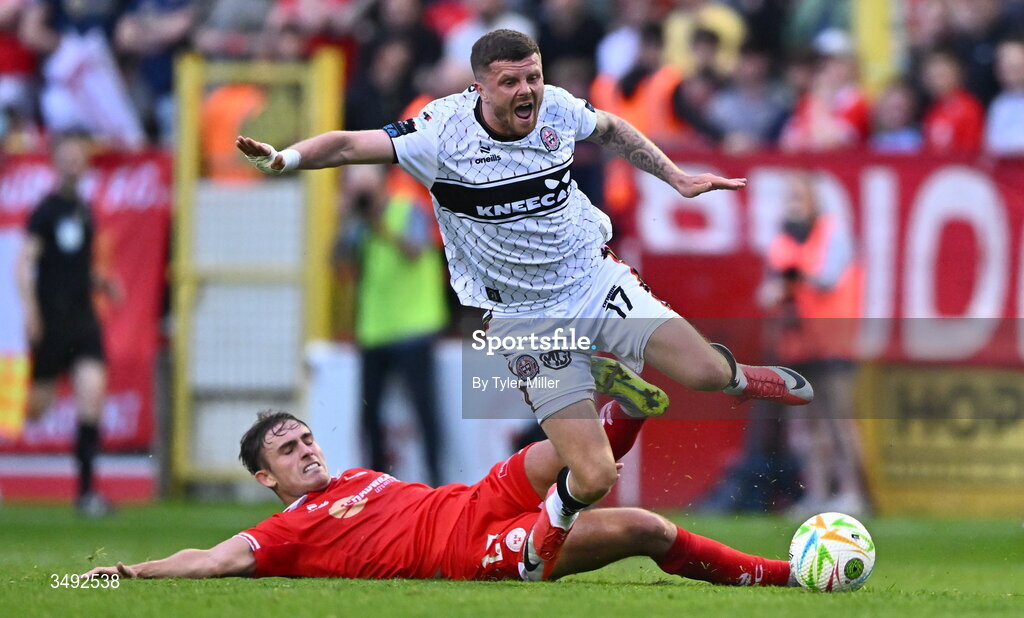 22 June 2026; Adam McDonnell of Bohemians is tackled by Evan Caffrey of Shelbourne during the SSE Airtricity Men’s Premier Division match between Shelbourne and Bohemians at Tolka Park in Dublin. Photo by Tyler Miller/Sportsfile
