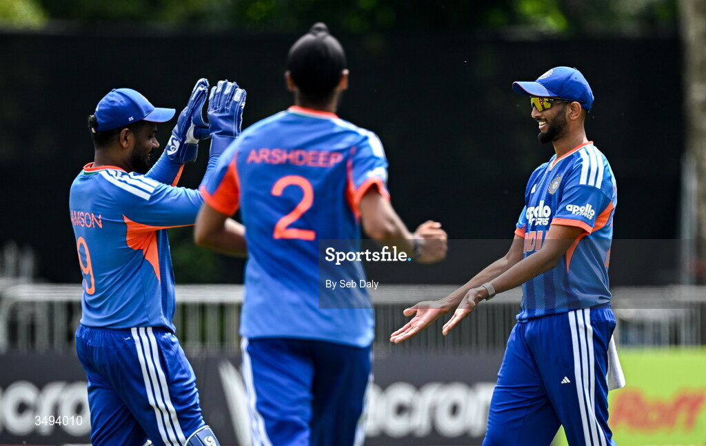 26 June 2026; Prasidh Krishna of India, right, is congratulated by teammate wicketkeeper Sanju Samson, left, after taking the wicket of Ireland batter Ben Calitz during match one of the Spinny Cup Men's T20 International series between Ireland and India at Stormont in Belfast. Photo by Seb Daly/Sportsfile