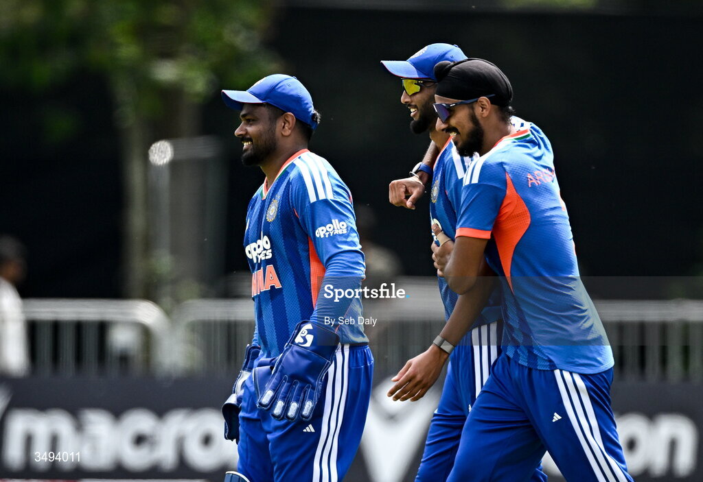 26 June 2026; India fielder Prasidh Krishna, centre, is congratulated by wicketkeeper Sanju Samson, left, and Arshdeep Singh after taking the wicket of Ireland batter Ben Calitz during match one of the Spinny Cup Men's T20 International series between Ireland and India at Stormont in Belfast. Photo by Seb Daly/Sportsfile