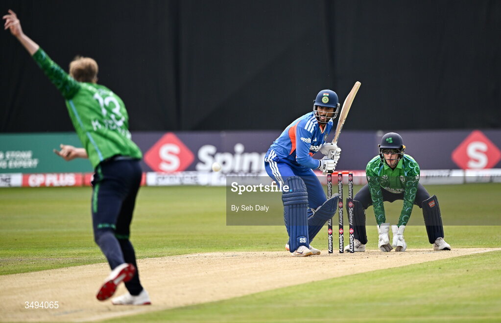26 June 2026; India batter Tilak Varma, plays a shot, watched by Ireland wicketkeeper Lorcan Tucker, during match one of the Spinny Cup Men's T20 International series between Ireland and India at Stormont in Belfast. Photo by Seb Daly/Sportsfile