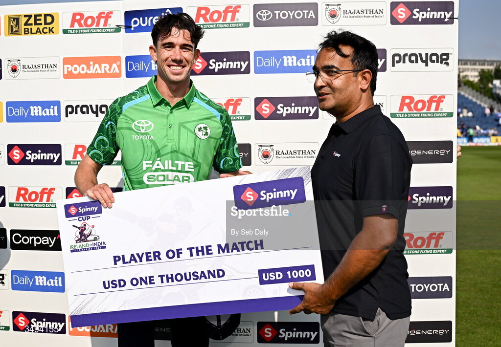 26 June 2026; Ireland's Matthew Hollard is presented with the Player of the Match Award by Spinny founder and chief executive Niraj Singh after match one of the Spinny Cup Men's T20 International series between Ireland and India at Stormont in Belfast. Photo by Seb Daly/Sportsfile