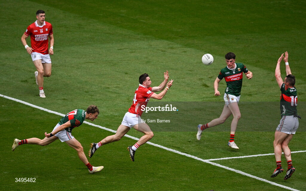 27 June 2026; Chris Óg Jones of Cork scores a point despite the efforts of Diarmuid Duffy, left, and Stephen Coen of Mayo during the GAA Football All-Ireland Senior Championship quarter-final match between Cork and Mayo at Croke Park in Dublin. Photo by Sam Barnes/Sportsfile