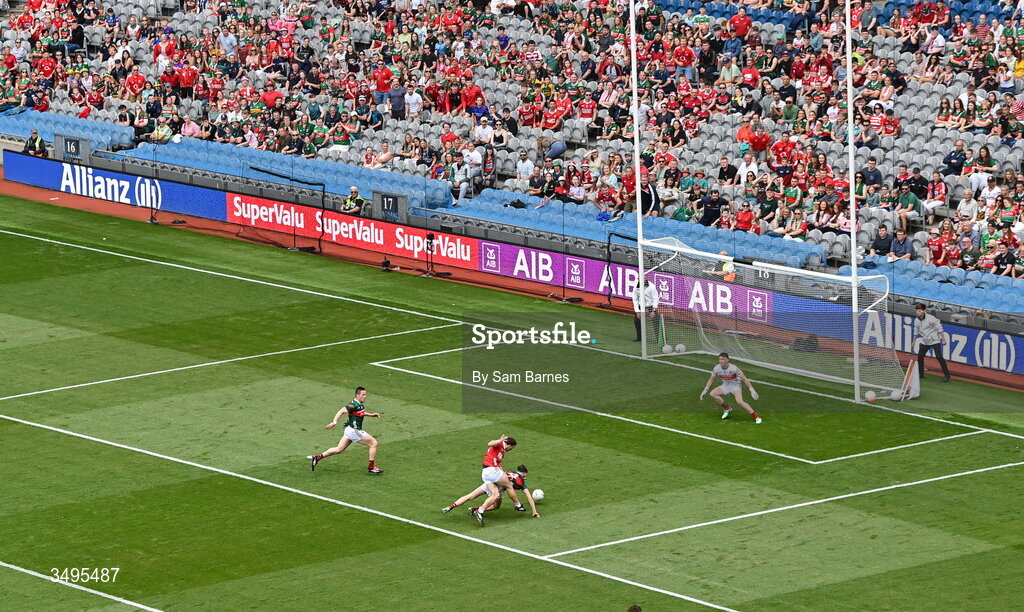 27 June 2026; Chris Óg Jones of Cork has a shot on goal despite the efforts of Eoin McGreal of Mayo during the GAA Football All-Ireland Senior Championship quarter-final match between Cork and Mayo at Croke Park in Dublin. Photo by Sam Barnes/Sportsfile