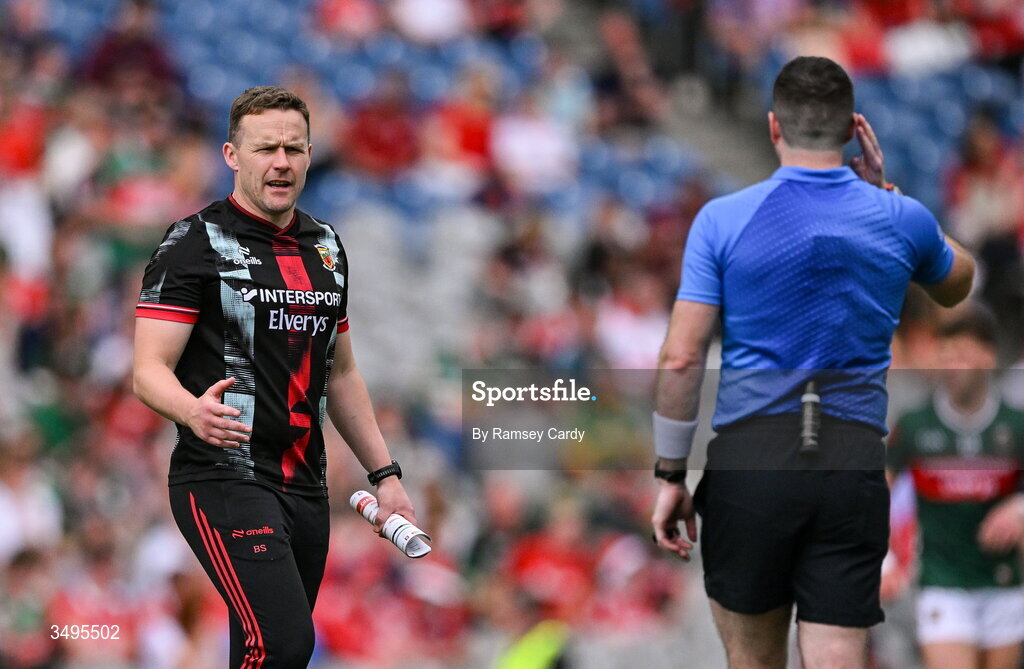27 June 2026; Mayo manager Andy Moran speaks with referee Martin McNally at half-time of the GAA Football All-Ireland Senior Championship quarter-final match between Cork and Mayo at Croke Park in Dublin. Photo by Ramsey Cardy/Sportsfile
