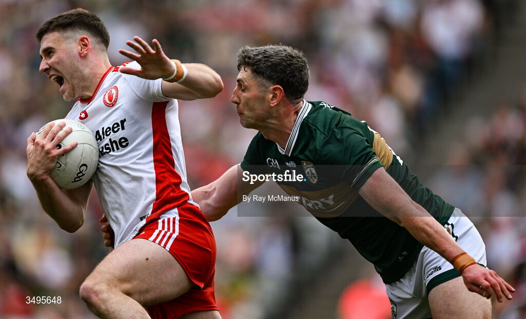 27 June 2026; Niall Devlin of Tyrone is tackled by Paul Geaney of Kerry during the GAA Football All-Ireland Senior Championship quarter-final match between Kerry and Tyrone at Croke Park in Dublin. Photo by Ray McManus/Sportsfile