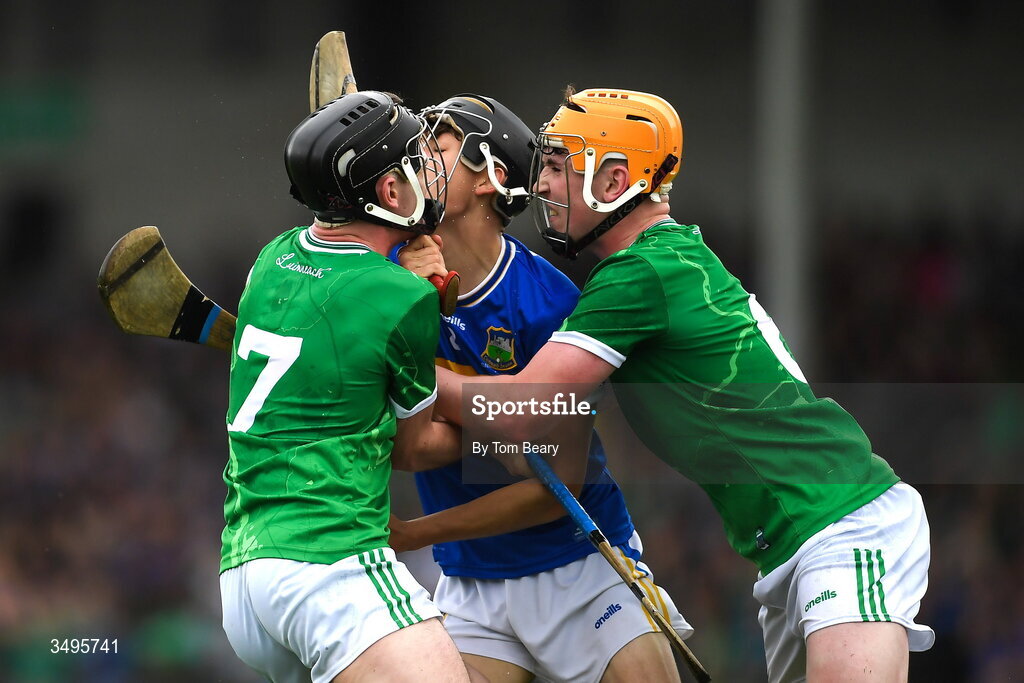 27 June 2026; Shane Ryan of Tipperary is tackled by Conor Ryan, left, and Eoin Hennessy of Limerick during the Electric Ireland All-Ireland Minor Hurling Championship final match between Limerick and Tipperary at TUS Gaelic Grounds in Limerick. Photo by Tom Beary/Sportsfile