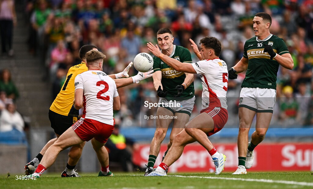 27 June 2026; Seán O'Shea of Kerry passes under pressure from Tyrone players, from left, goalkeeper Niall Morgan, Cormac Quinn and Michael McKernan during the GAA Football All-Ireland Senior Championship quarter-final match between Kerry and Tyrone at Croke Park in Dublin. Photo by Ben McShane/Sportsfile