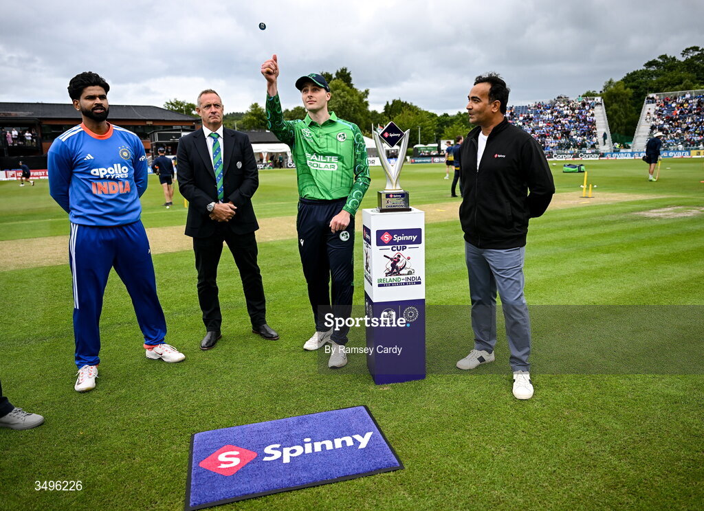 28 June 2026; Ireland captain Lorcan Tucker performs the coin toss in the company of India captain Shreyas Iyer and match referee Dean Cosker before match two of the Spinny Cup Men's T20 International series between Ireland and India at Stormont in Belfast.  Photo by Ramsey Cardy/Sportsfile