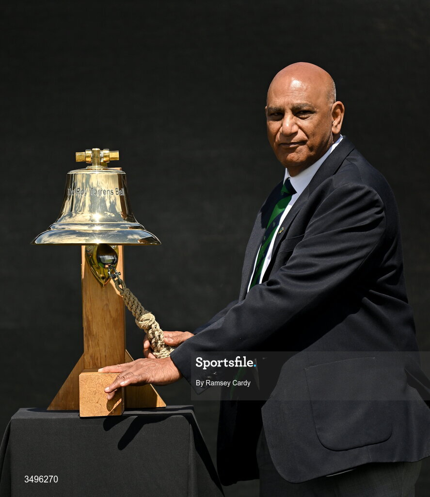 28 June 2026; Former Ireland and India international Bobby Rao rings The Roy Torrens Bell before match two of the Spinny Cup Men's T20 International series between Ireland and India at Stormont in Belfast. Photo by Ramsey Cardy/Sportsfile