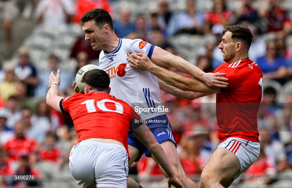 28 June 2026; Killian Lavelle of Monaghan is tackled by James Maguire, 10, and Mícheál Bannigan of Monaghan during the GAA Football All-Ireland Senior Championship quarter-final match between Louth and Monaghan at Croke Park in Dublin. Photo by Ray McManus/Sportsfile