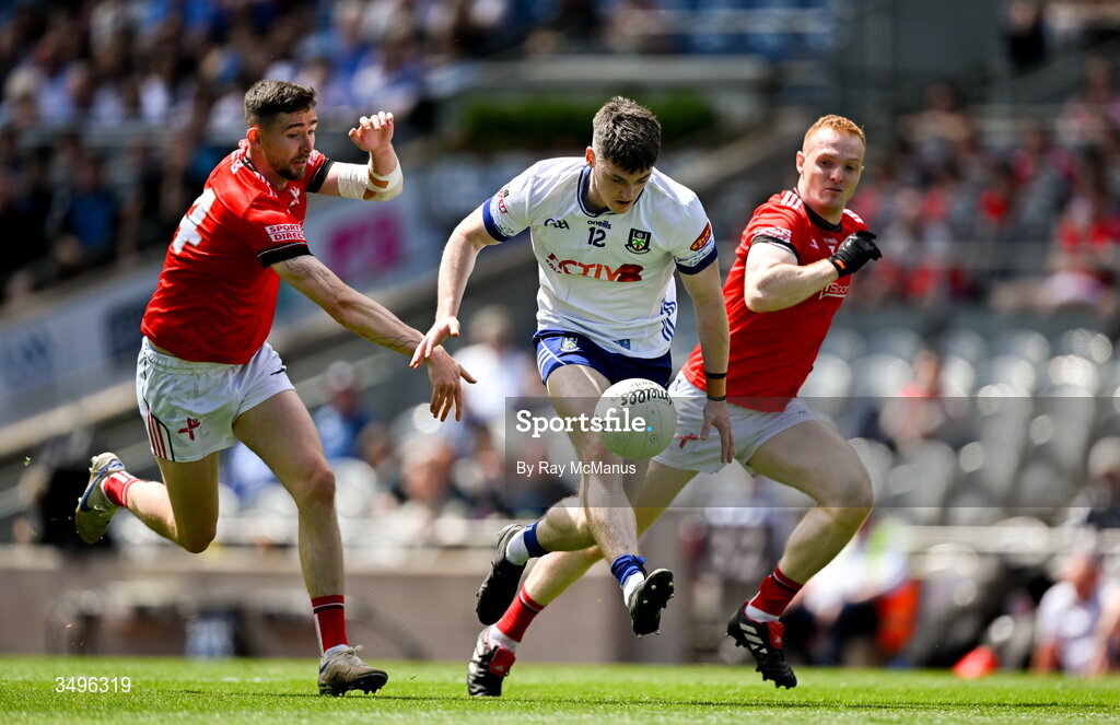 28 June 2026; Stephen O'Hanlon of Monaghan is tackled by Ciaran Downey, left, and Donal Mc Kenny of Louth during the GAA Football All-Ireland Senior Championship quarter-final match between Louth and Monaghan at Croke Park in Dublin. Photo by Ray McManus/Sportsfile