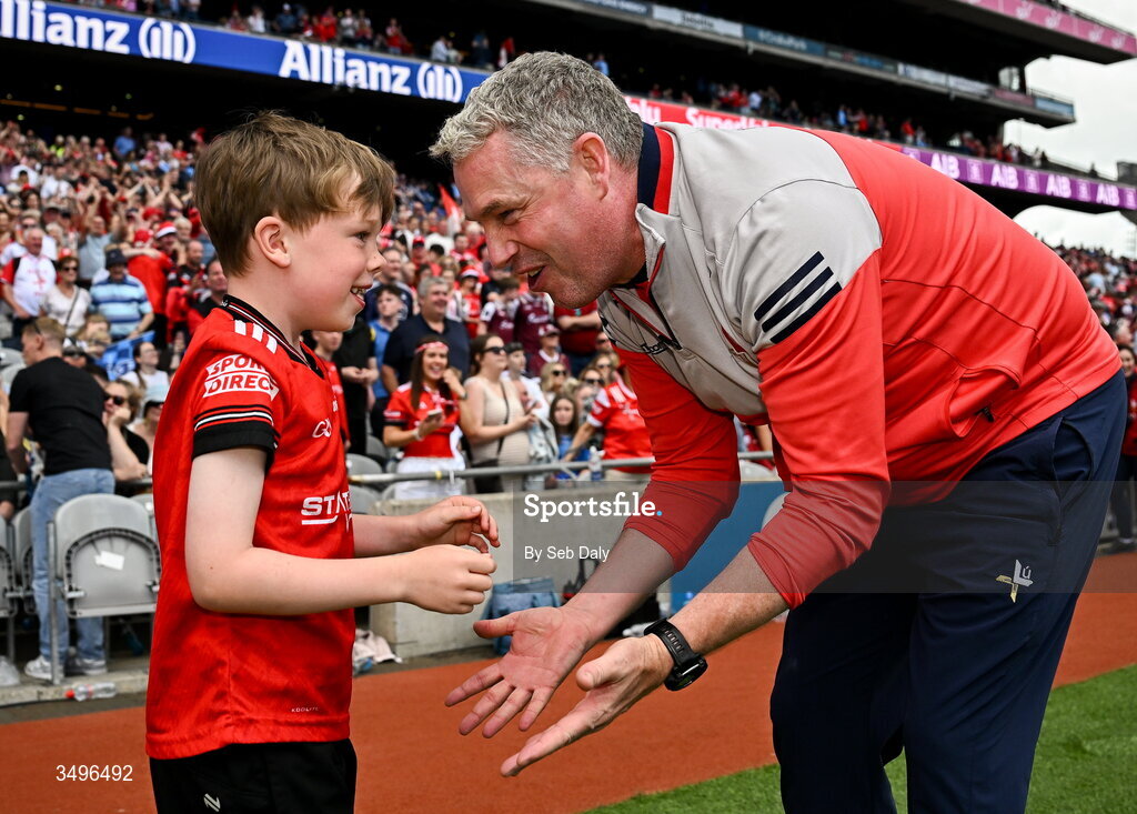 28 June 2026; Louth manager Gavin Devlin celebrates with his son Niall, age 7, after his side's victory in the GAA Football All-Ireland Senior Championship quarter-final match between Louth and Monaghan at Croke Park in Dublin. Photo by Seb Daly/Sportsfile