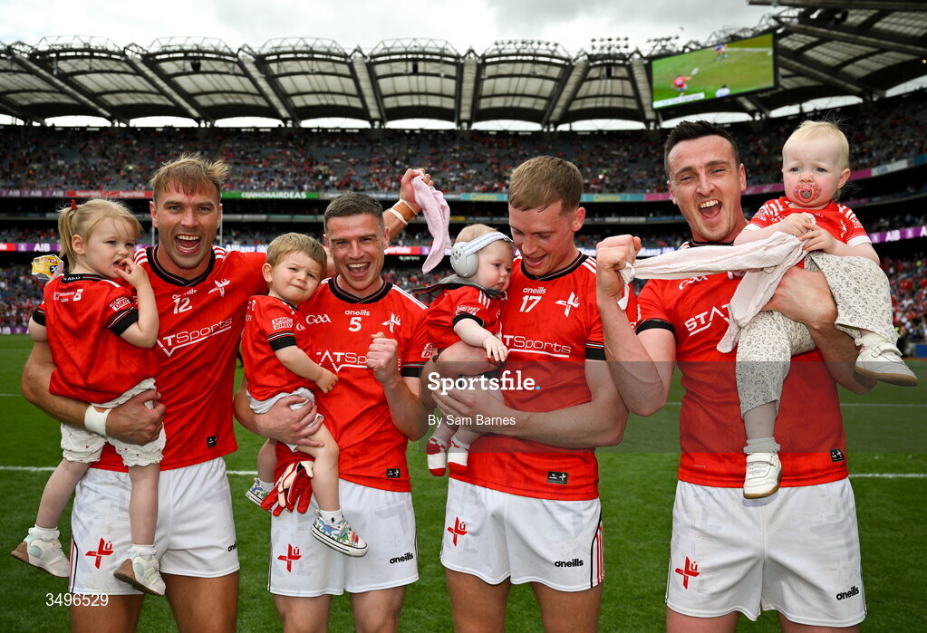 28 June 2026; Louth players, from left, Conor Grimes, Conal McKeever, Ciaran Byrne, and Tommy Durnin, celebrate with their young children after their side's victory in the GAA Football All-Ireland Senior Championship quarter-final match between Louth and Monaghan at Croke Park in Dublin. Photo by Sam Barnes/Sportsfile