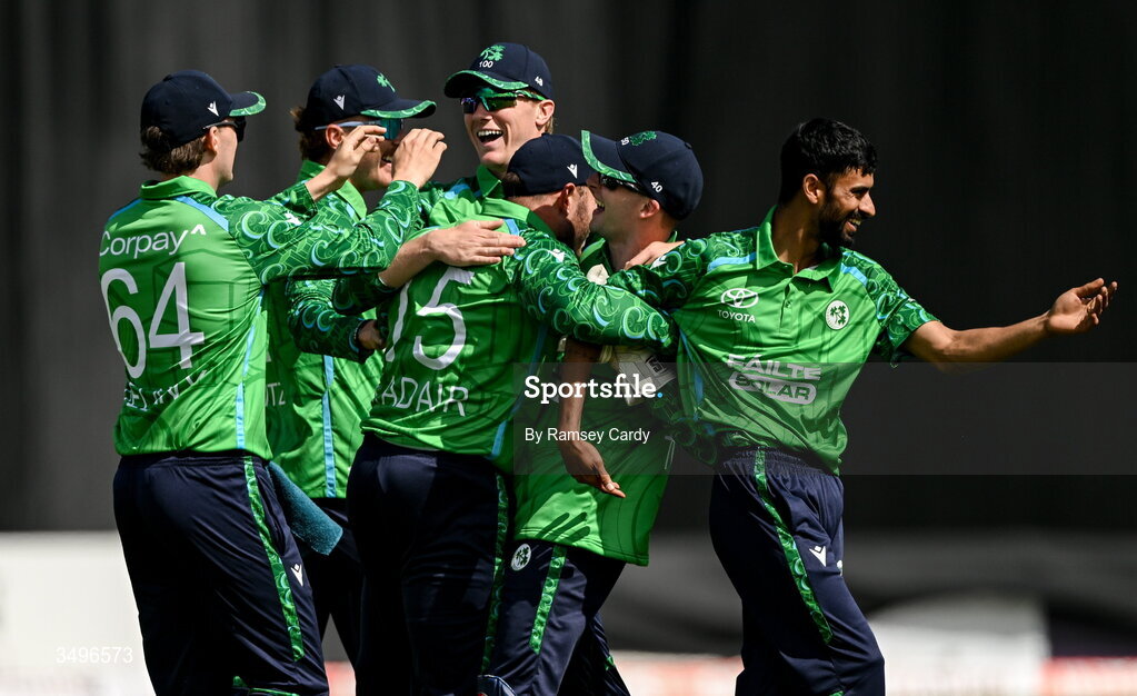 28 June 2026; Ross Adair, centre, celebrates with Ireland teammates after taking the wicket of Ishan Kishan of India during match two of the Spinny Cup Men's T20 International series between Ireland and India at Stormont in Belfast.  Photo by Ramsey Cardy/Sportsfile