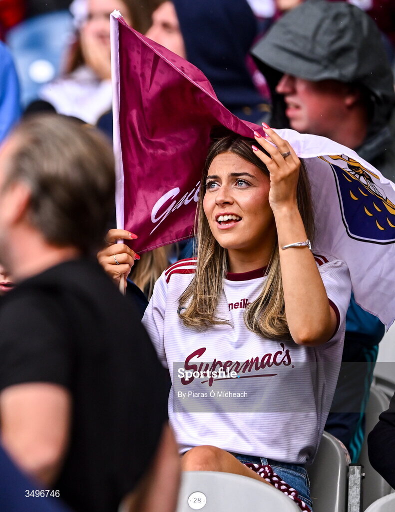 28 June 2026; A Galway supporter uses her flag to shelter from the rain during the GAA Football All-Ireland Senior Championship quarter-final match between Dublin and Galway at Croke Park in Dublin. Photo by Piaras Ó Mídheach/Sportsfile