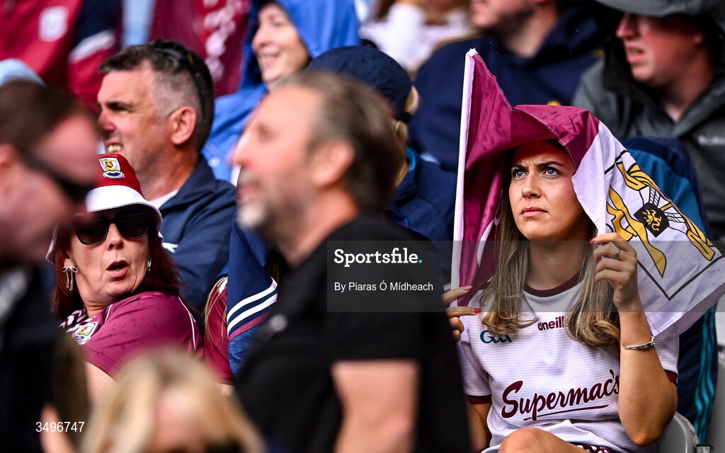 28 June 2026; A Galway supporter uses her flag to shelter from the rain during the GAA Football All-Ireland Senior Championship quarter-final match between Dublin and Galway at Croke Park in Dublin. Photo by Piaras Ó Mídheach/Sportsfile