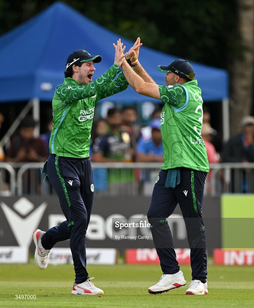 28 June 2026; Liam McCarthy of Ireland celebrates with George Dockrell, left, after taking the wicket of Tilak Varma of India during match two of the Spinny Cup Men's T20 International series between Ireland and India at Stormont in Belfast. Photo by Ramsey Cardy/Sportsfile