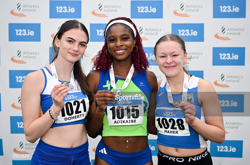 4 July 2026; Under 20 women's 100m medallists, Chidinma Adikaibe of Metro/St Brigids AC, Dublin, centre, gold, Nicole Doherty of Ratoath AC, Meath, left, silver, and Alisha Maher of Tullamore Harriers AC, Offaly, right, bronze, during day one of the 123.ie National U20 & U23 Track & Field Championships at Tullamore Harriers Athletics Club in Tullamore, Offaly. Photo by Sam Barnes/Sportsfile