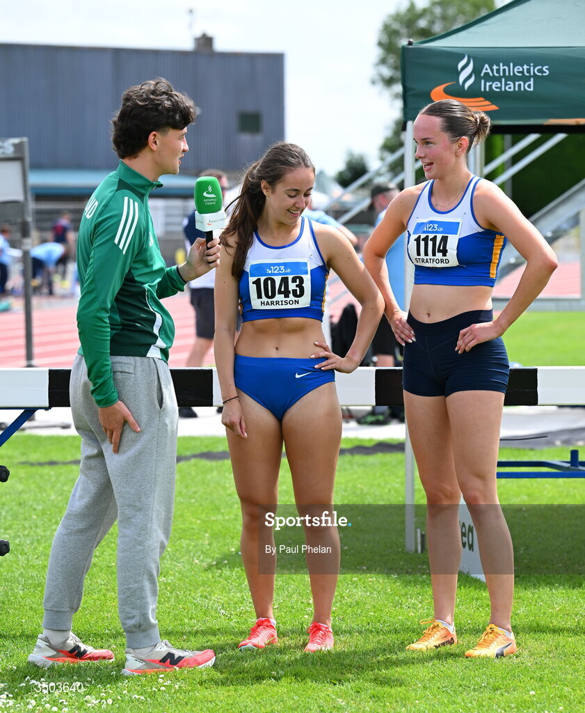 5 July 2026; Athletics Ireland content creator and marketing operations officer Cillian Sheerin interviews Lorena Harrison  and Aisling Stratford of Ratoath A.C., after they fininshed first sand second in the U23 women's 200m during day two of the 123.ie National U20 & U23 Track & Field Championships at Tullamore Harriers Athletics Club in Tullamore, Offaly. Photo by Paul Phelan/Sportsfile