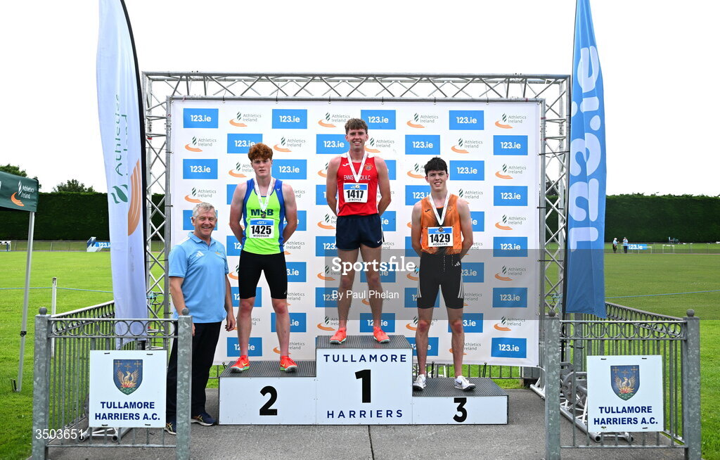 5 July 2026; Cian O'Boyle of Ennis Track A.C., centre, in first, Louie Woodger of Metro/St. Brigids A.C., left, in second and Cian Hodgins of Nenagh Olympic A.C., right, in third, alongside Chair of Competition Commission Micael Quinlan after the U23 men's 1500m during day two of the 123.ie National U20 & U23 Track & Field Championships at Tullamore Harriers Athletics Club in Tullamore, Offaly. Photo by Paul Phelan/Sportsfile