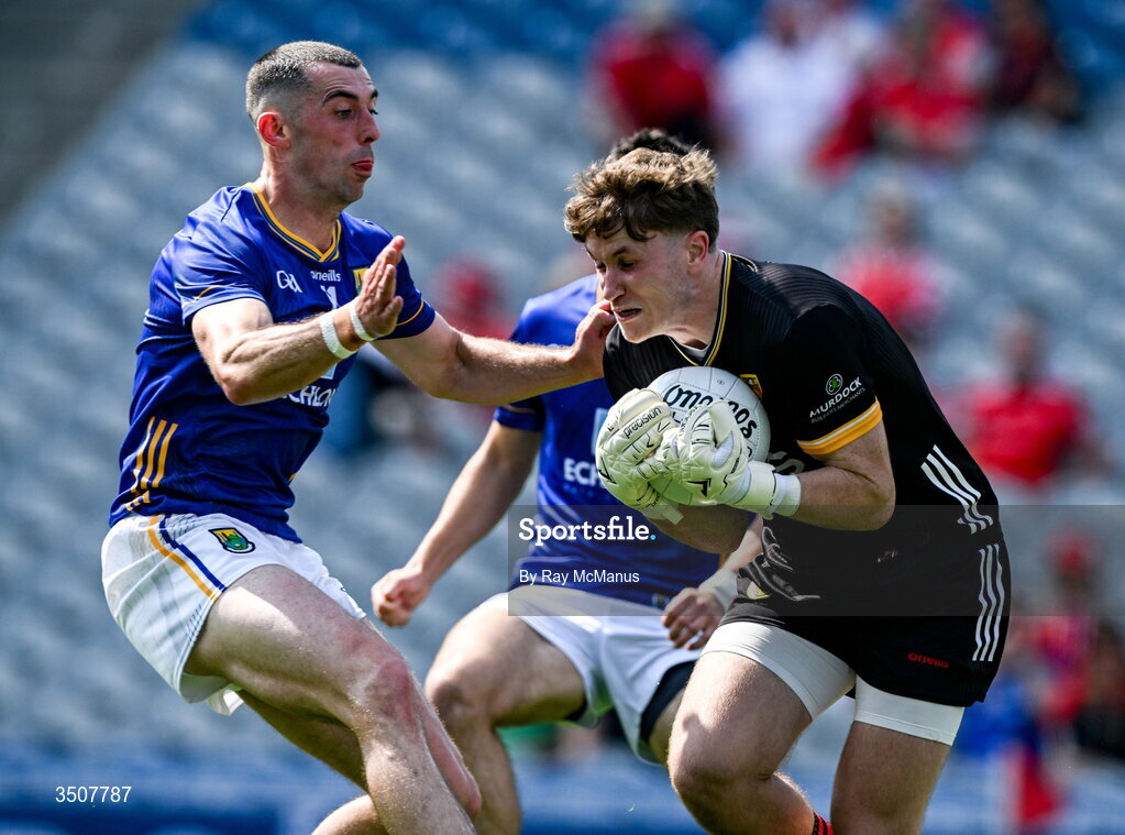 11 July 2026; Down goalkeeper Ronan Burns is tackled by Padraig O'Toole of Wicklow during the Tailteann Cup final match between Down and Wicklow at Croke Park in Dublin. Photo by Ray McManus/Sportsfile