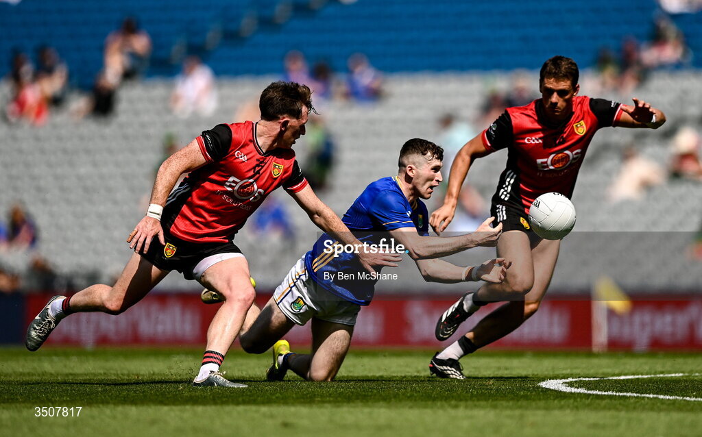11 July 2026; Tom Moran of Wicklow gets a pass away despite the tackle of Miceal Rooney, left, and Pat Havern of Down during the Tailteann Cup final match between Down and Wicklow at Croke Park in Dublin. Photo by Ben McShane/Sportsfile