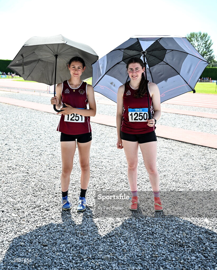 11 July 2026; Ruby Blake and Grace Norton of Crookstown Millview A.C. protect themselves from the sun with umbrellas during day three of the 123.ie National Championships at Tullamore Harriers Athletics Club in Tullamore, Offaly.     Photo by Paul Phelan/Sportsfile