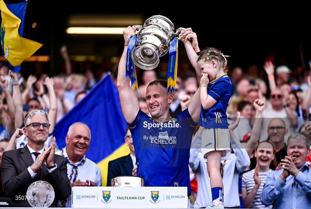 11 July 2026; Wicklow captain Dean Healy lifts the Tailteann Cup alongside his daughter Fiádh after the Tailteann Cup final match between Down and Wicklow at Croke Park in Dublin. Photo by Ben McShane/Sportsfile