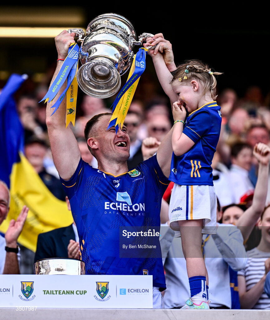 11 July 2026; Wicklow captain Dean Healy lifts the Tailteann Cup alongside his daughter Fiádh after the Tailteann Cup final match between Down and Wicklow at Croke Park in Dublin. Photo by Ben McShane/Sportsfile