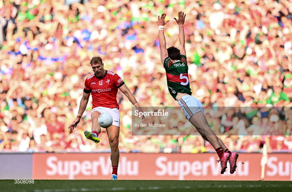 11 July 2026; Conor Grimes of Louth kicks a point under pressure from Sam Callinan of Mayo during the GAA Football All-Ireland Senior Championship semi-final match between Mayo and Louth at Croke Park in Dublin. Photo by Ben McShane/Sportsfile