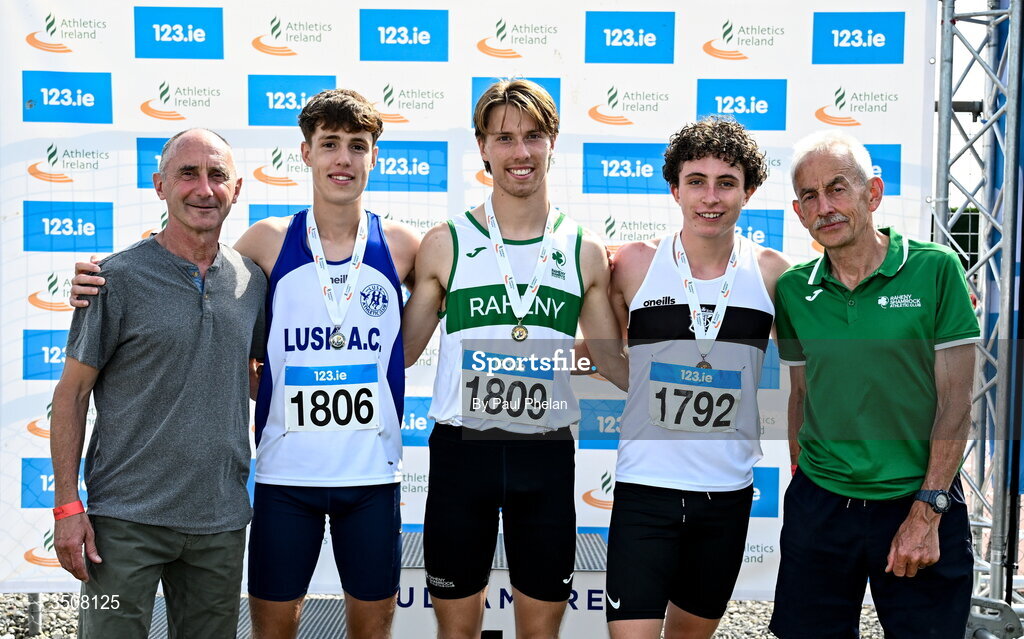 11 July 2026; Conrad Latham of Raheny Shamrock A.C., centre, in first, Conor Mcguirk of Lusk A.C., second from left, in second, Harry Moran of Donore Harriers A.C., fourth from left, in third, alongside olympians Marcus O'Sullivan and Dick Hooper, after the U19 boy's 1500m during day three of the 123.ie National Championships at Tullamore Harriers Athletics Club in Tullamore, Offaly. Photo by Paul Phelan/Sportsfile