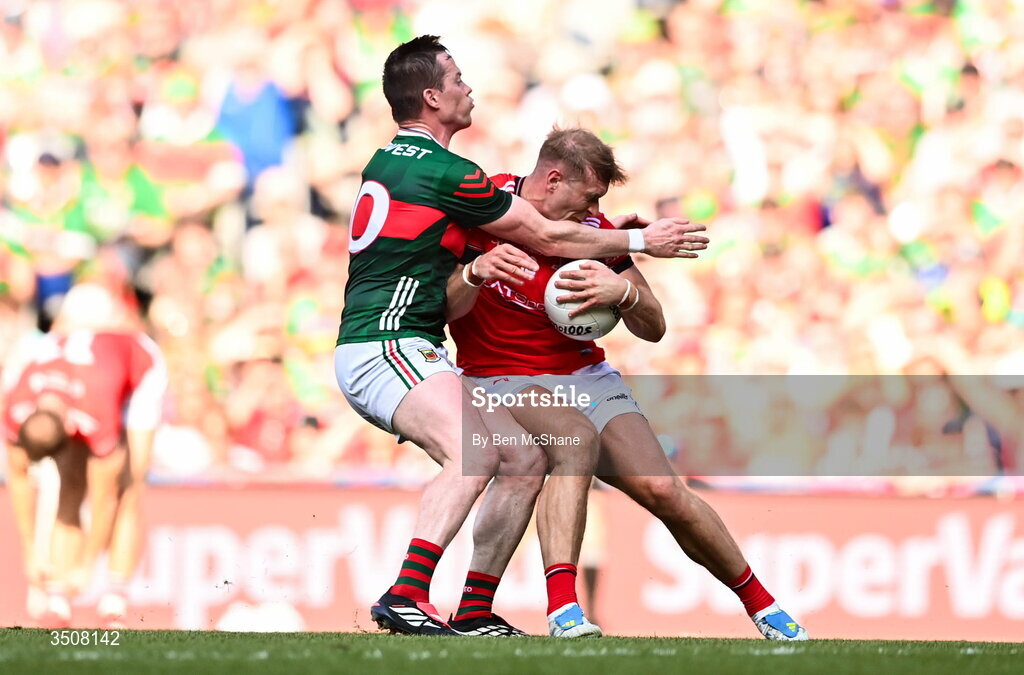 11 July 2026; Conor Grimes of Louth is tackled by Stephen Coen of Mayo during the GAA Football All-Ireland Senior Championship semi-final match between Mayo and Louth at Croke Park in Dublin. Photo by Ben McShane/Sportsfile