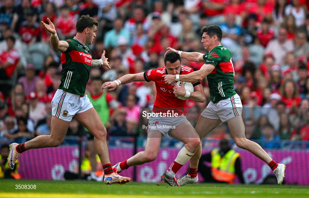 11 July 2026; Tommy Durnin of Louth is tackled by Jordan Flynn and Conor Loftus of Mayo during the GAA Football All-Ireland Senior Championship semi-final match between Mayo and Louth at Croke Park in Dublin. Photo by Ray McManus/Sportsfile