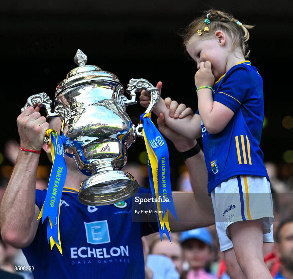 11 July 2026; Dean Healy of Wicklow and his five year old daughter, Fiádh, lift the Tailteann Cup after the final between Down and Wicklow at Croke Park in Dublin. Photo by Ray McManus/Sportsfile