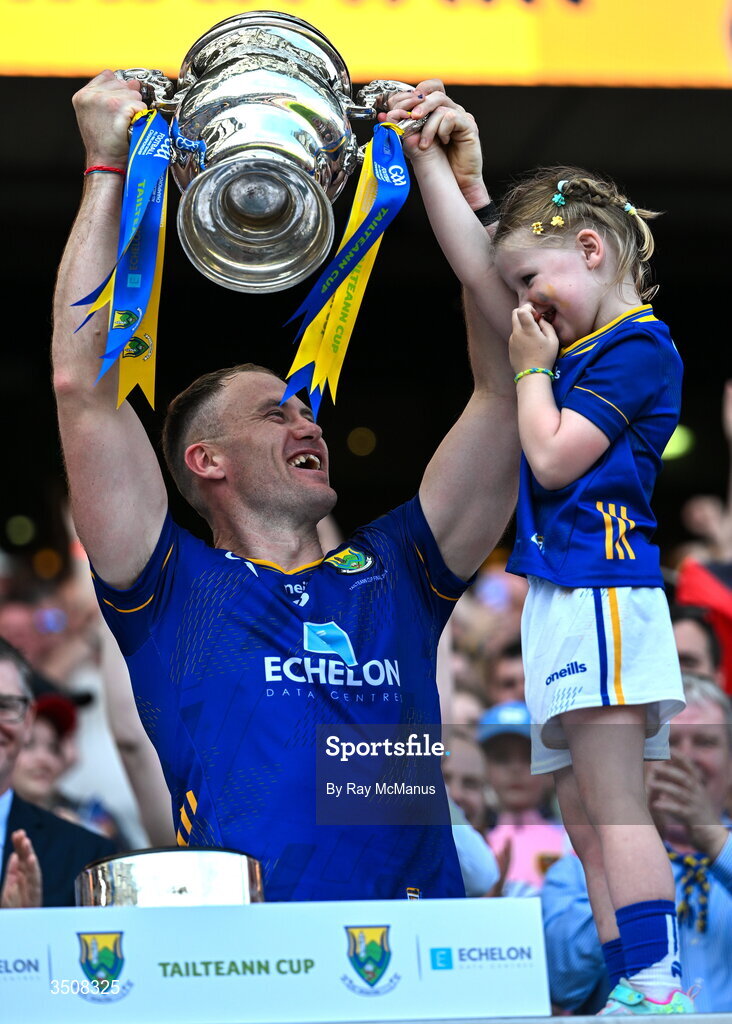 11 July 2026; Dean Healy of Wicklow and his five year old daughter, Fiádh, lift the Tailteann Cup after the final between Down and Wicklow at Croke Park in Dublin. Photo by Ray McManus/Sportsfile