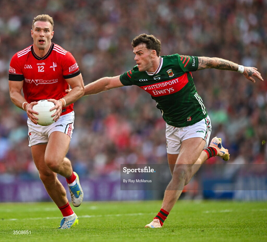11 July 2026; Conor Grimes of Louth is tackled by Jordan Flynn of Mayo during the GAA Football All-Ireland Senior Championship semi-final match between Mayo and Louth at Croke Park in Dublin. Photo by Ray McManus/Sportsfile