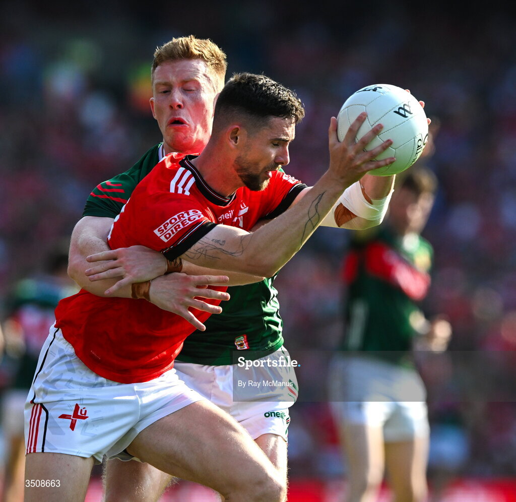 11 July 2026; Ciaran Downey of Louth is tackled by David McBrien of Mayo during the GAA Football All-Ireland Senior Championship semi-final match between Mayo and Louth at Croke Park in Dublin. Photo by Ray McManus/Sportsfile