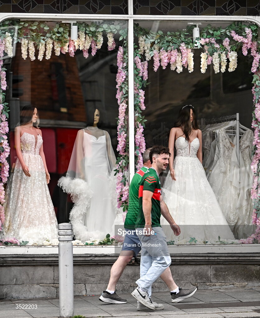 26 July 2026; Mayo supporters walk past a bridal shop before the GAA Football All-Ireland Senior Championship final match between Kerry and Mayo at Croke Park in Dublin. Photo by Piaras Ó Mídheach/Sportsfile