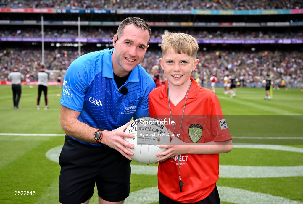 26 July 2026; Darragh Ó Raifeartaigh, aged 12, from Swords in Dublin, right, presents the match ball to referee Martin McNally ahead of the GAA Football All-Ireland Senior Championship final match between Kerry and Mayo at Croke Park in Dublin. Photo by Stephen McCarthy/Sportsfile