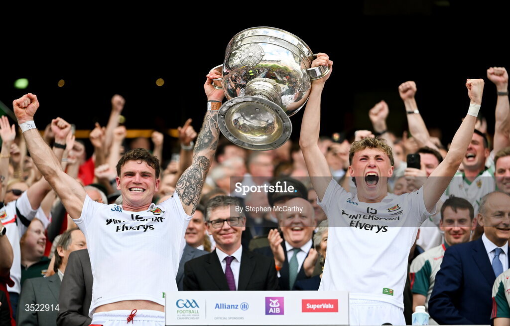 26 July 2026; Mayo players Jordan Flynn, left, and Kobe McDonald lift the Sam Maguire Cup after their side's victory in the GAA Football All-Ireland Senior Championship final match between Kerry and Mayo at Croke Park in Dublin. Photo by Stephen McCarthy/Sportsfile