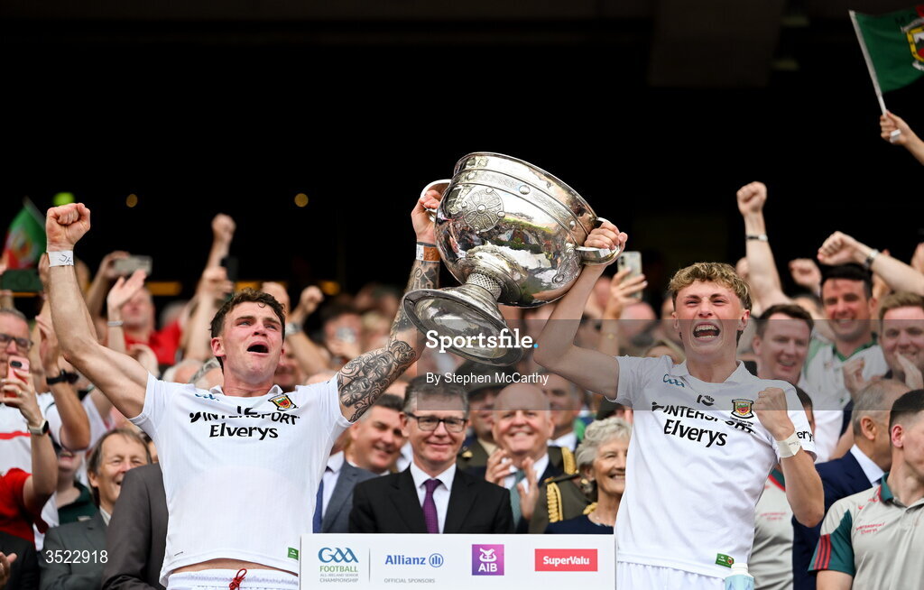 26 July 2026; Mayo players Jordan Flynn, left, and Kobe McDonald lift the Sam Maguire Cup after their side's victory in the GAA Football All-Ireland Senior Championship final match between Kerry and Mayo at Croke Park in Dublin. Photo by Stephen McCarthy/Sportsfile