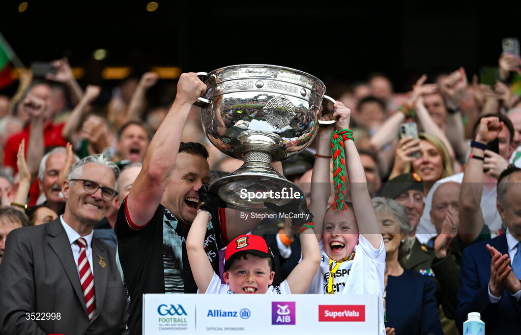 26 July 2026; Mayo manager Andy Moran lifts the Sam Maguire Cup with his son Ollie and his daughter Charlotte after the GAA Football All-Ireland Senior Championship final match between Kerry and Mayo at Croke Park in Dublin. Photo by Stephen McCarthy/Sportsfile