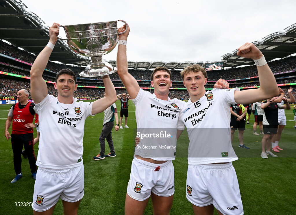 26 July 2026; Mayo players, from left, Conor Loftus, Jordan Flynn and Kobe McDonald celebrate with the Sam Maguire Cup following the GAA Football All-Ireland Senior Championship final match between Kerry and Mayo at Croke Park in Dublin. Photo by Stephen McCarthy/Sportsfile