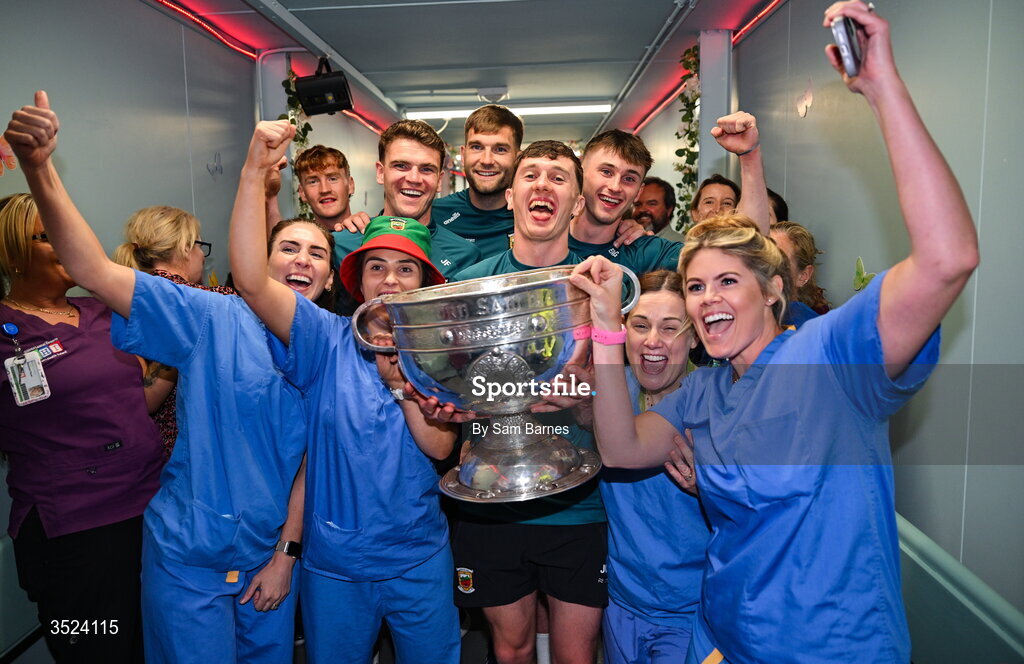 27 July 2026; Mayo players, from left, Jordan Flynn, Aidan O'Shea, Jack Coyne, and Eoin McGreal with nurses from the CHI Temple Street in Dublin after being crowned All-Ireland Senior Football champions following their victory over Kerry in the GAA All-Ireland Senior Football Championship final at Croke Park on Sunday. Photo by Sam Barnes/Sportsfile