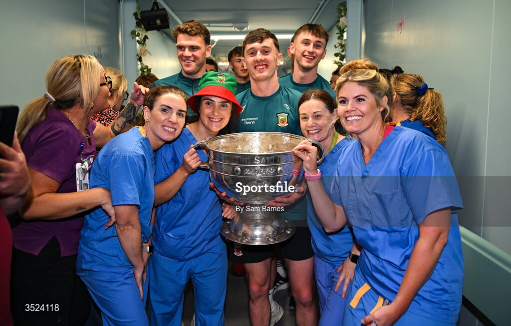 27 July 2026; Mayo players, from left, Jordan Flynn, Aidan O'Shea, Jack Coyne, and Eoin McGreal with nurses from the CHI Temple Street in Dublin after being crowned All-Ireland Senior Football champions following their victory over Kerry in the GAA All-Ireland Senior Football Championship final at Croke Park on Sunday. Photo by Sam Barnes/Sportsfile