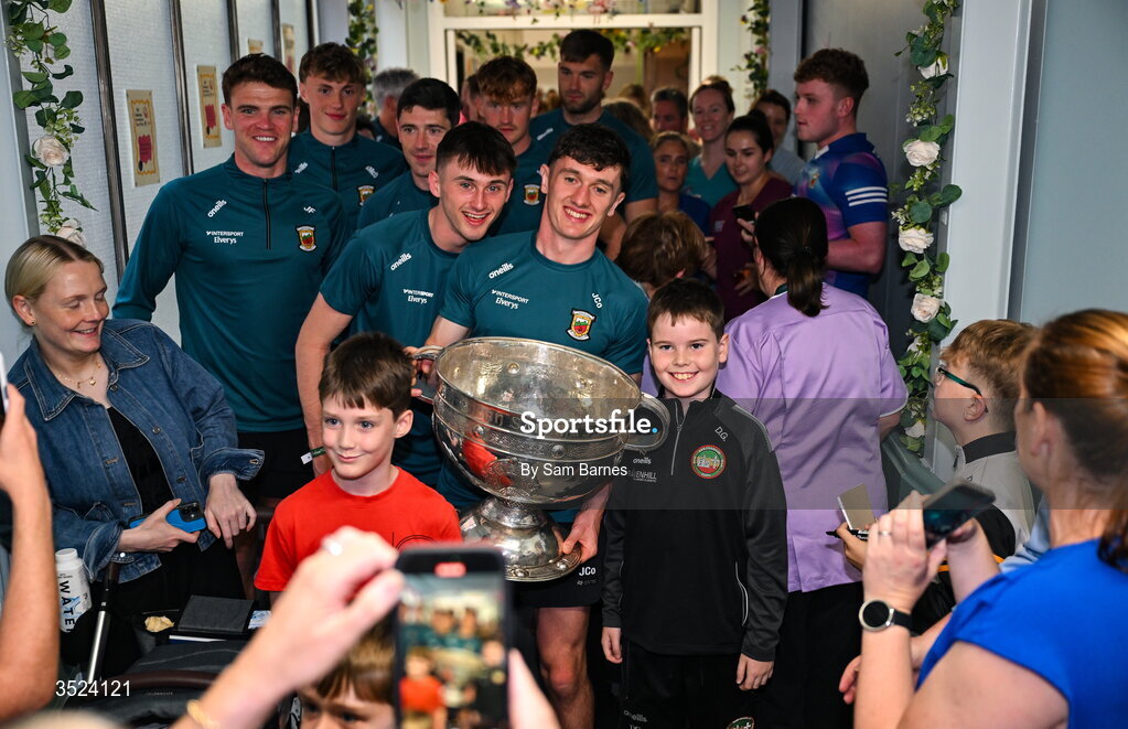 27 July 2026; Mayo players Jack Coyne, right, and Eoin McGreal with teammates and supporters at the CHI Temple Street in Dublin after being crowned All-Ireland Senior Football champions following their victory over Kerry in the GAA All-Ireland Senior Football Championship final at Croke Park on Sunday. Photo by Sam Barnes/Sportsfile