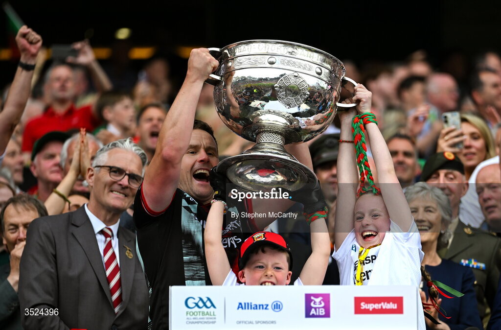 26 July 2026; Mayo manager Andy Moran lifts the Sam Maguire Cup with his son Ollie and his daughter Charlotte after the GAA Football All-Ireland Senior Championship final match between Kerry and Mayo at Croke Park in Dublin.  Photo by Stephen McCarthy/Sportsfile