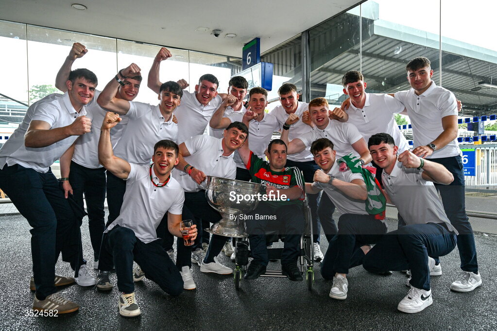 27 July 2026; Mayo players and supporter Stephen Monahan, from Wicklow, and his father being from Claremorris. celebrate with the Sam Maguire Cup at Heuston Station in Dublin after being crowned All-Ireland Senior Football champions following their victory over Kerry in the GAA All-Ireland Senior Football Championship final at Croke Park on Sunday.  Photo by Sam Barnes/Sportsfile